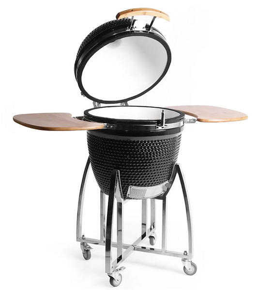 Black ceramic kamado grill with open lid, wooden side shelves and a metal stand with caster wheels.
