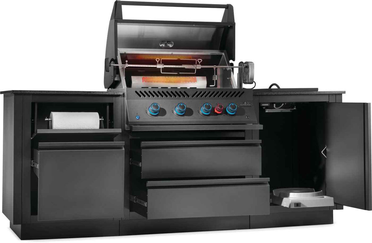Napoleon OASIS modular outdoor kitchen with glowing rear infrared burner, rotisserie and open storage cabinets.