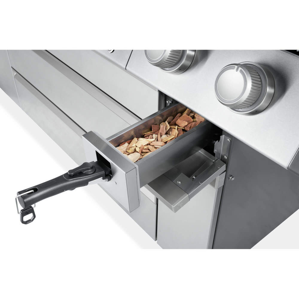 Close-up of the Prestige PRO 665 Elite smoker drawer pulled open and filled with wood chips.